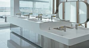 Island style sinks in the centre of the restroom with views of the runway