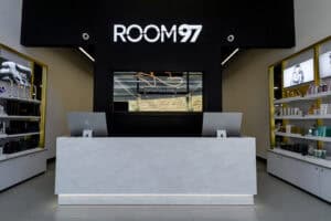 front desk of a salon, grand and luxury with white solid surface as the desk with macs on the desk