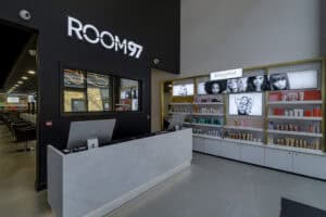 front desk of a salon, grand and luxury with white solid surface as the desk with macs on the desk